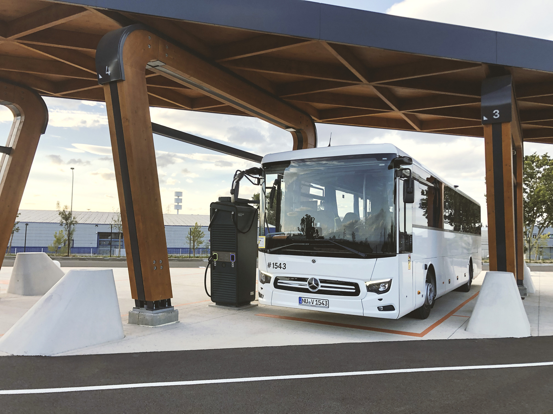 Example photo of a near-production prototype Mercedes-Benz eIntouro at a public charging station operated by Milence. Daimler Buses launches expansion of public charging stations